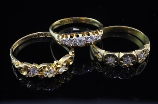 Three late 19th/early 20th century 18ct gold and diamond set rings, sizes M,P & S.